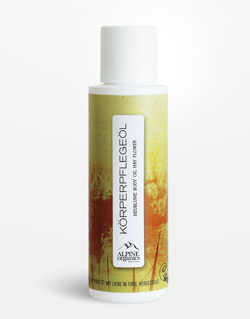 Körperpflegeöl mit Heublume & Haselnussöl für ein seidig-weiches Hautgefühl | Bio & Vegan, in weißer Flasche von ALPINE Organics, vegan zertifiziert.