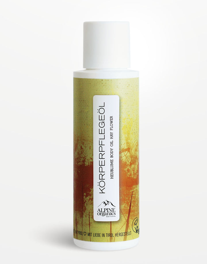 Körperpflegeöl mit Heublume & Haselnussöl für ein seidig-weiches Hautgefühl | Bio & Vegan, in weißer Flasche von ALPINE Organics, vegan zertifiziert.