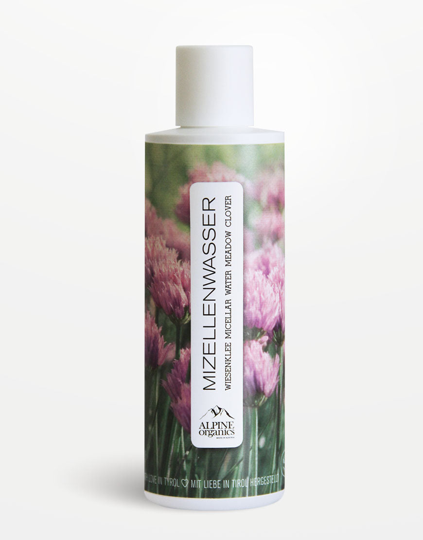 Mizellenwasser mit Wiesenklee & Aloe von Alpine Organics, zylindrische Flasche, pinke Klee-Blüten auf grünem Hintergrund, sanfte Reinigung, feuchtigkeitsspendend, vegan, für empfindliche Haut.