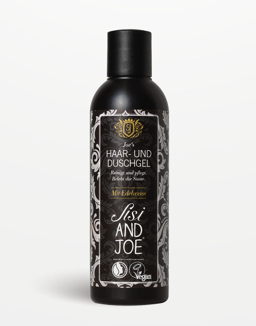 Tall, schwarze Flasche Joe’s Haar- und Duschgel von Sisi & Joe, vegan, mit Apfel- und Brennnessel-Extrakt, dekoratives Blumenetikett.