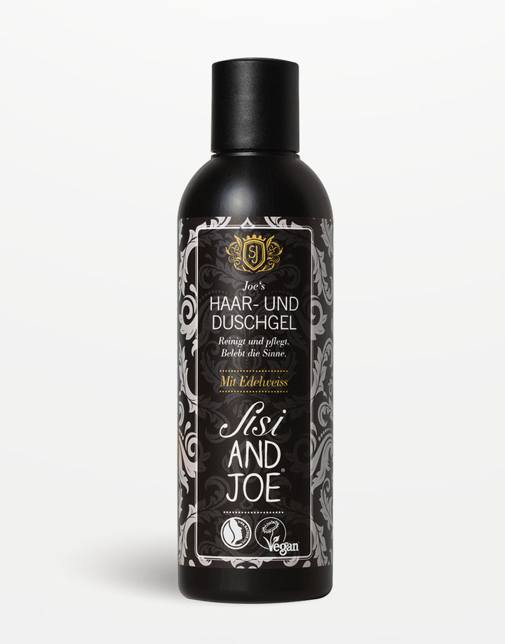 Tall, schwarze Flasche Joe’s Haar- und Duschgel von Sisi & Joe, vegan, mit Apfel- und Brennnessel-Extrakt, dekoratives Blumenetikett.
