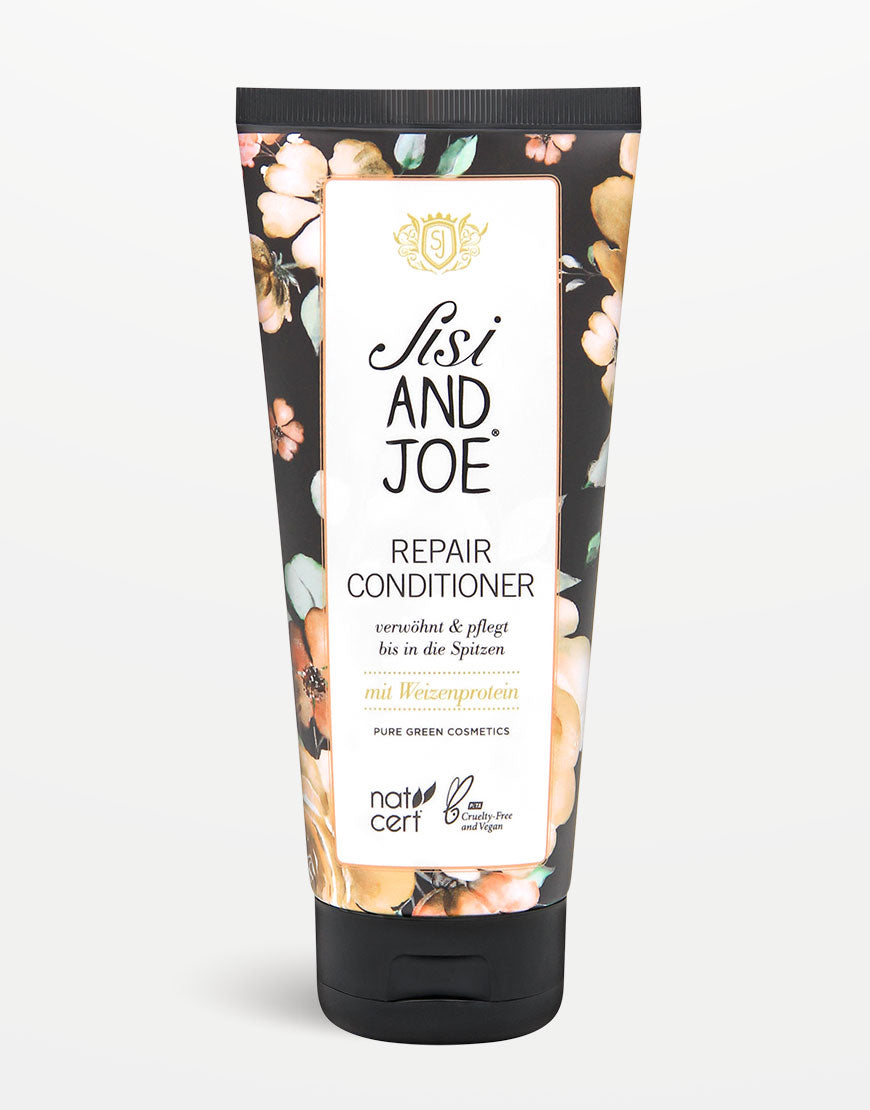 Sisi and Joe Protein-Boost Repair Conditioner: Schwarze Kappe, floral verziertes Tube, Weizenprotein, Traubenkernöl, regeneriert Haare, ultimativer Glanz, bio, vegan, cruelty-free.