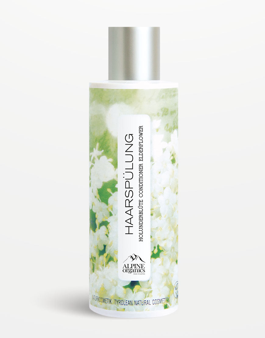 Flasche Haarspülung mit Holunder & Haselnussöl von Alpine Organics, grünes Blumendesign. 100% vegan, spendet Glanz und Feuchtigkeit, Tiroler Naturkosmetik.
