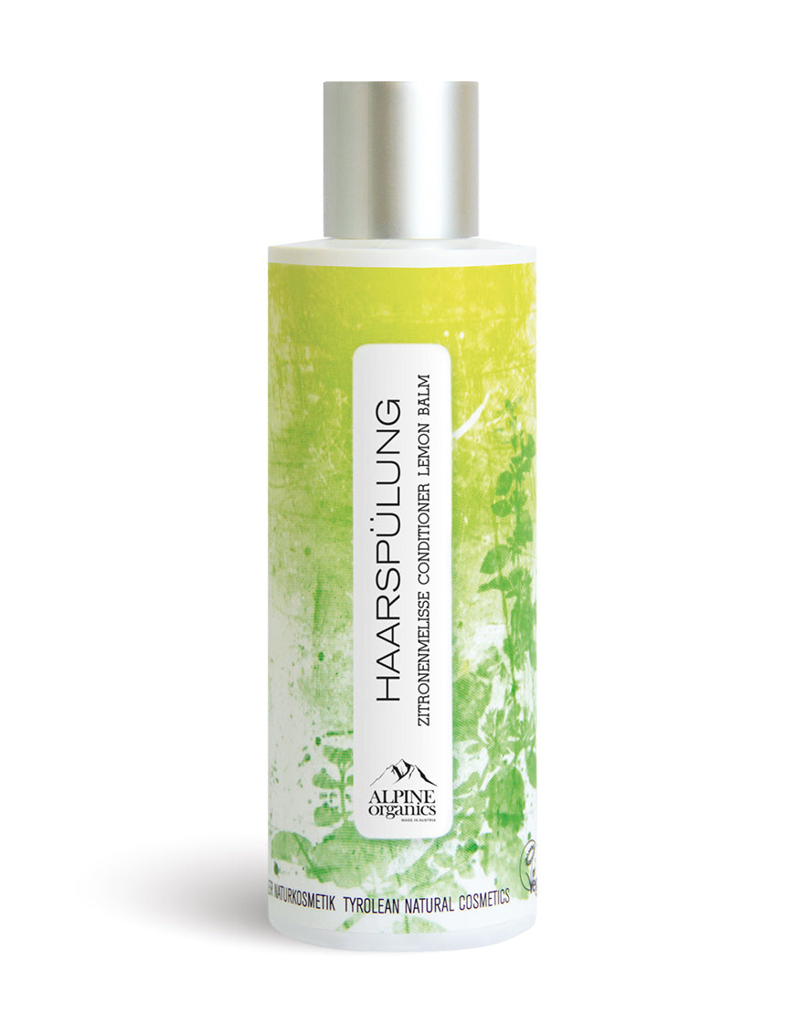 Haarspülung Zitronenmelisse mit Hagebutte für glänzende & geschmeidige Haare. Bio & vegan, in grüner Flasche mit botanischem Design, silberner Schraubverschluss.