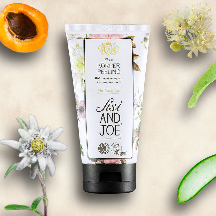 Sisi and Joe Körperpeeling mit Aprikosenkern-Peelingkörnern, Edelweißextrakt, vegan zertifiziert, umgeben von Aprikose, Aloe Vera, Edelweiß, Lindenblüten. Sanfte Rückstands-Entfernung für glatte, vitale Haut.