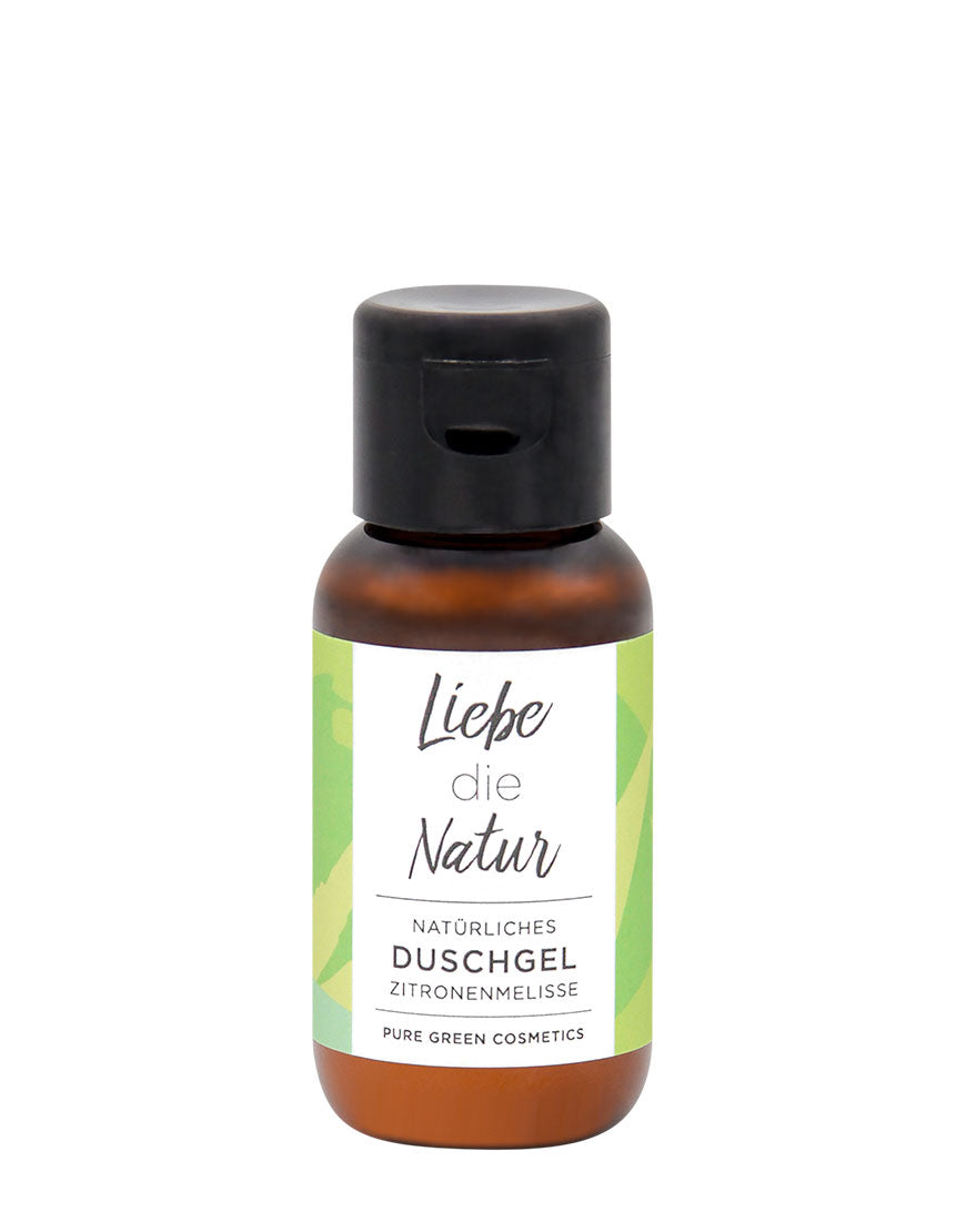 Kleine, bernsteinfarbene Flasche mit schwarzem Klappdeckel. Etikett: Liebe die Natur Zitronenmelisse-Duschgel für sanfte Reinigung und belebendes Pflegeerlebnis. Bio & vegan.
