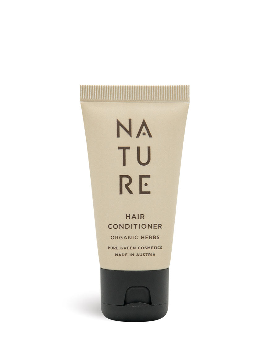 Reisegröße Conditioner mit Sonnenblumenöl & Haselnussöl, Bio & Vegan, in beige Tube mit schwarzem Klappverschluss, für glattes, leicht kämmbares Haar.