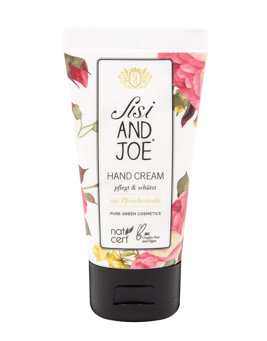 Peachy Kiss Handcreme mit Pfirsichextrakt & Aloe-Vera in weißer Tube mit floralen Mustern; vegan, cruelty-free, pflegt Hände und Nägel seidig-weich.